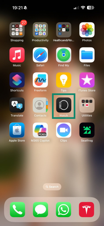 An iPhone home screen. The "Watch" app is highlighted.